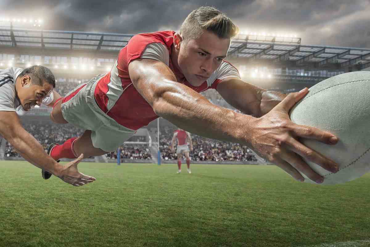 Giocatore di rugby si lancia per prendere la palla